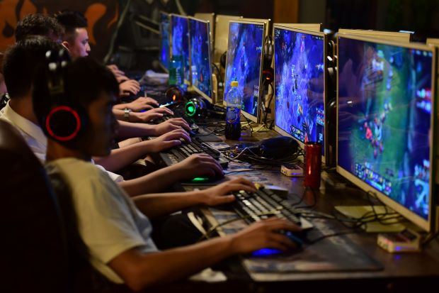PC gamers playing online games at an Internet cafe in Fuyang, Anhui province, China.